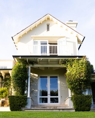 Modern house with white facade and greenery, showcasing beautiful architecture. exterior, contemporary, design, landscaping